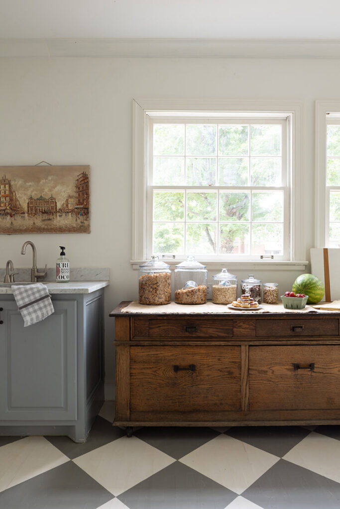 An old countertop in the walk-in pantry with pantry foods and an extra sink.