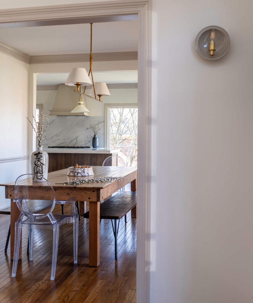 Hallway leading to a custom dining room, with white walls and tope trim.