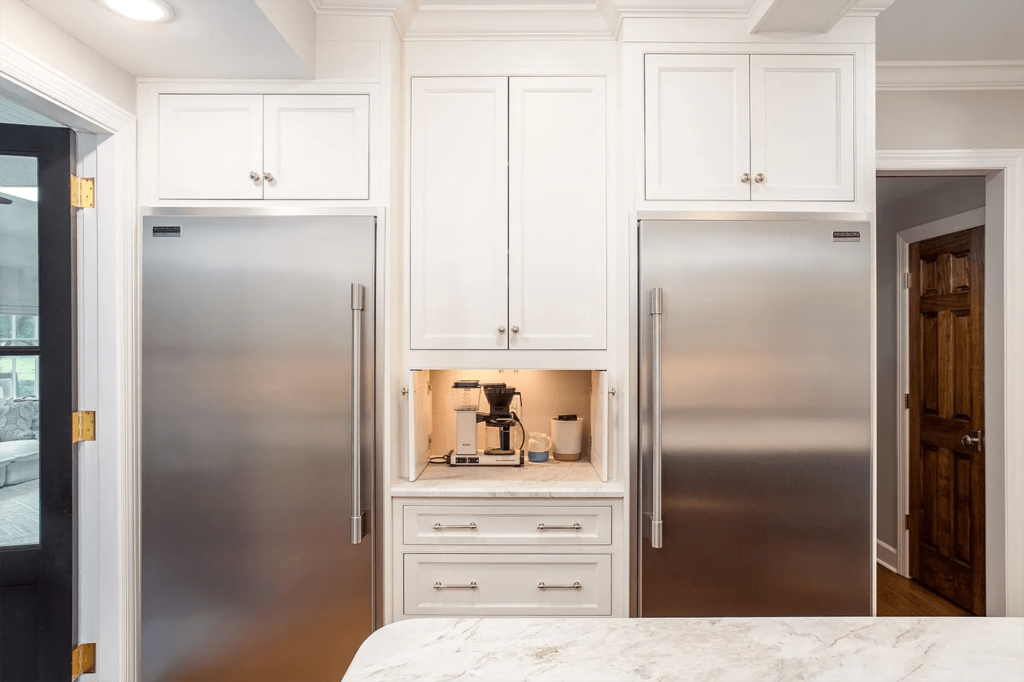 The custom cabinetry has inset doors, marble countertops and polished nickel weighted hardware.